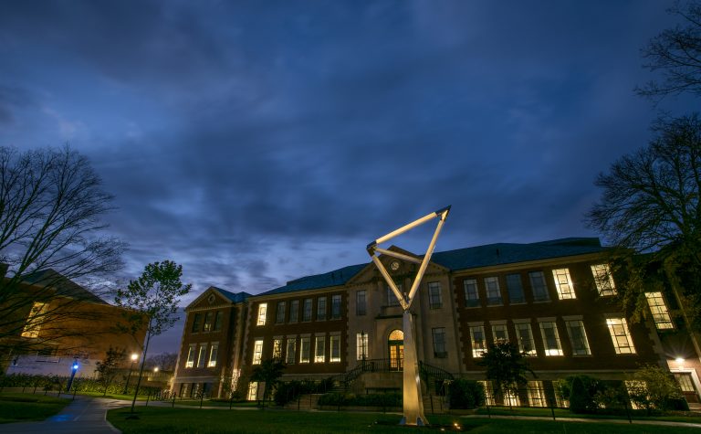 Castleman Building lit up at night under a dark sky.