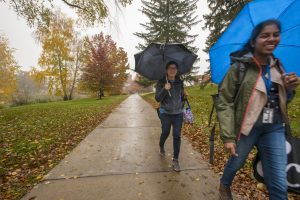 Students walking to class on a rainy fall day.