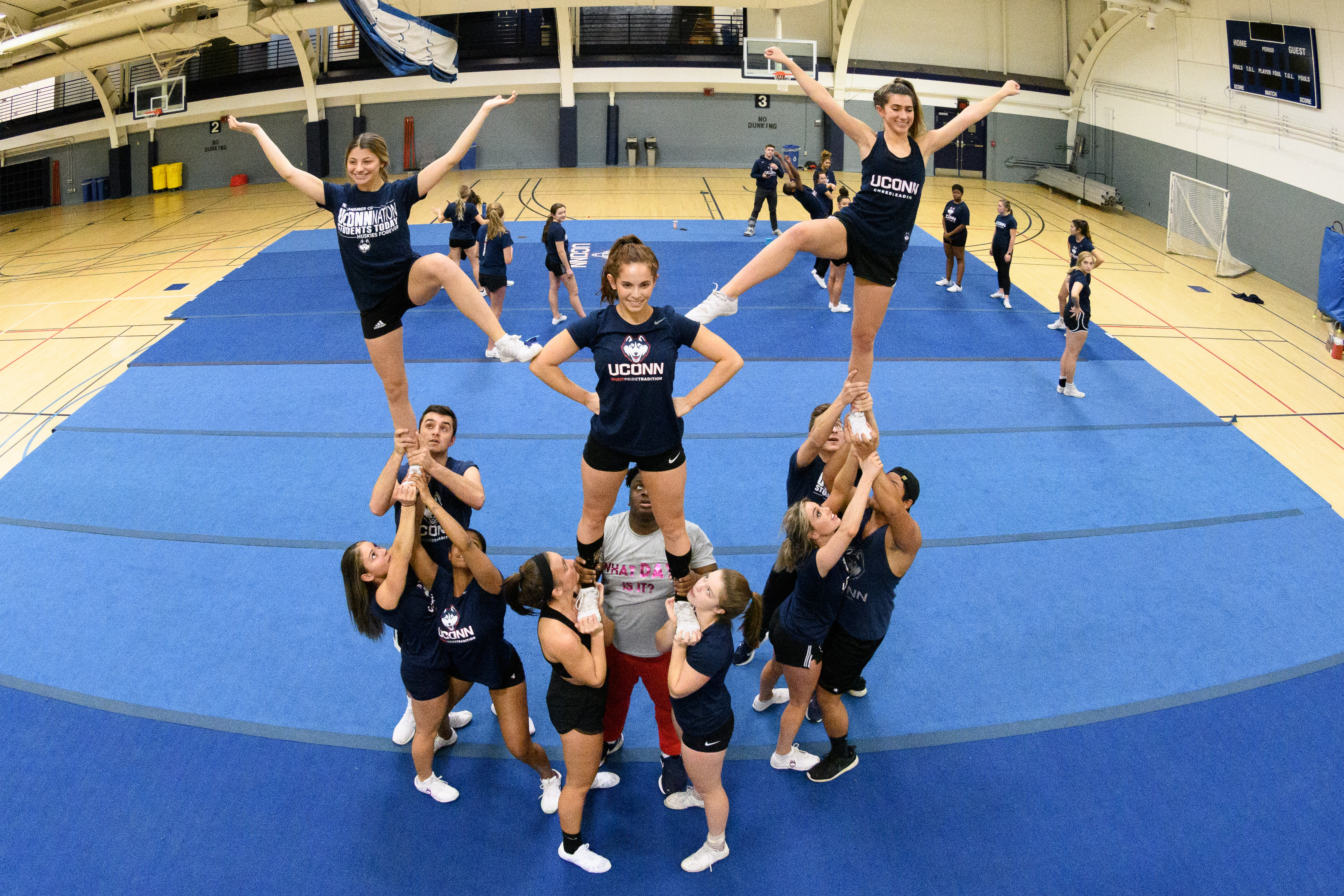 Cheerleaders practicing a routine.