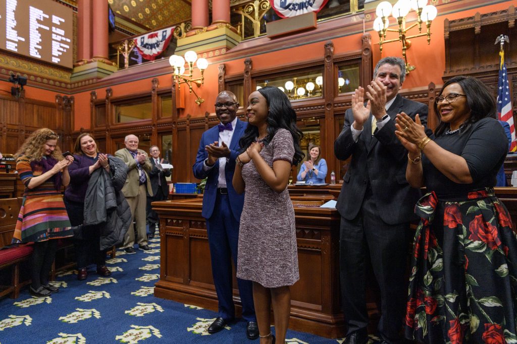 UConn Rhodes Scholar Wawa Gatheru is applauded by state lawmakers in Hartford.