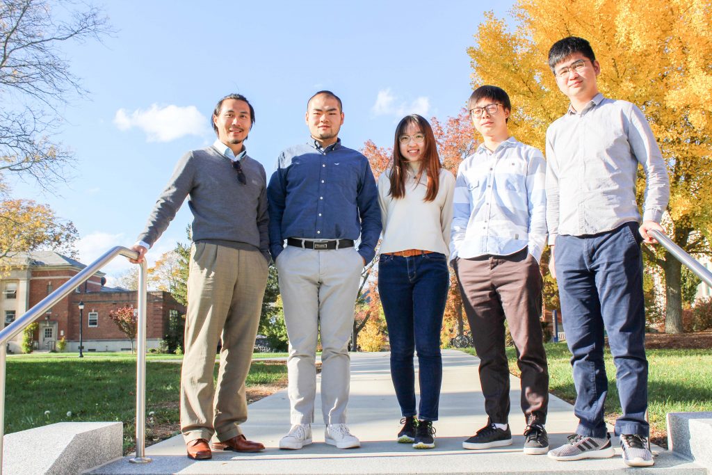 Zhe Zhu with graduate students from his lab outside in the fall.