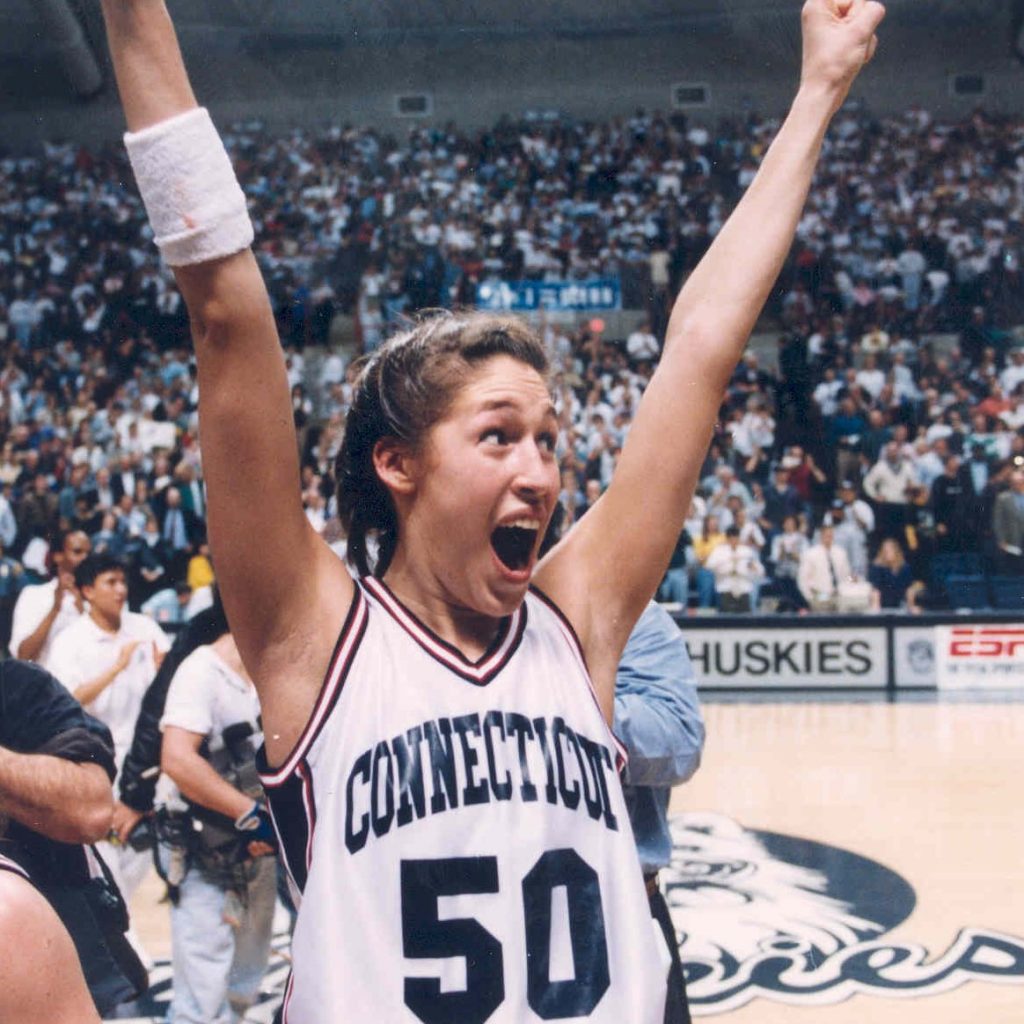 Rebecca Lobo with her arms raised.