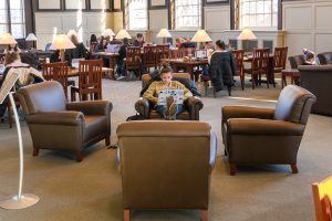 A student puts her feet up while studying at the Wilbur Cross South Reading Room.
