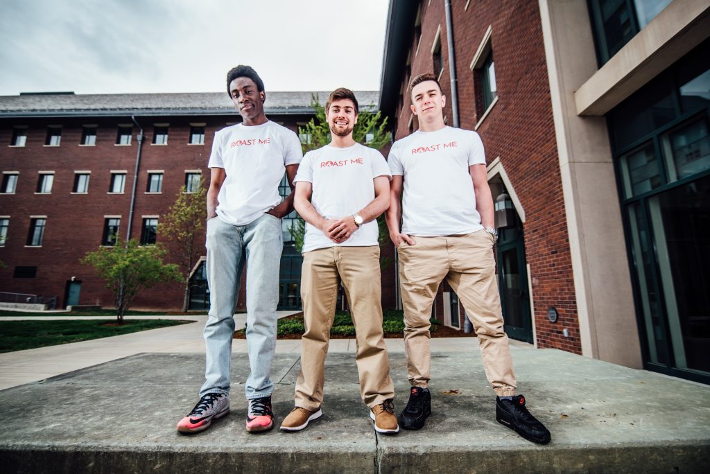 The three creators of the "Roast Me" card game pose for a portrait at the UConn School of Business.
