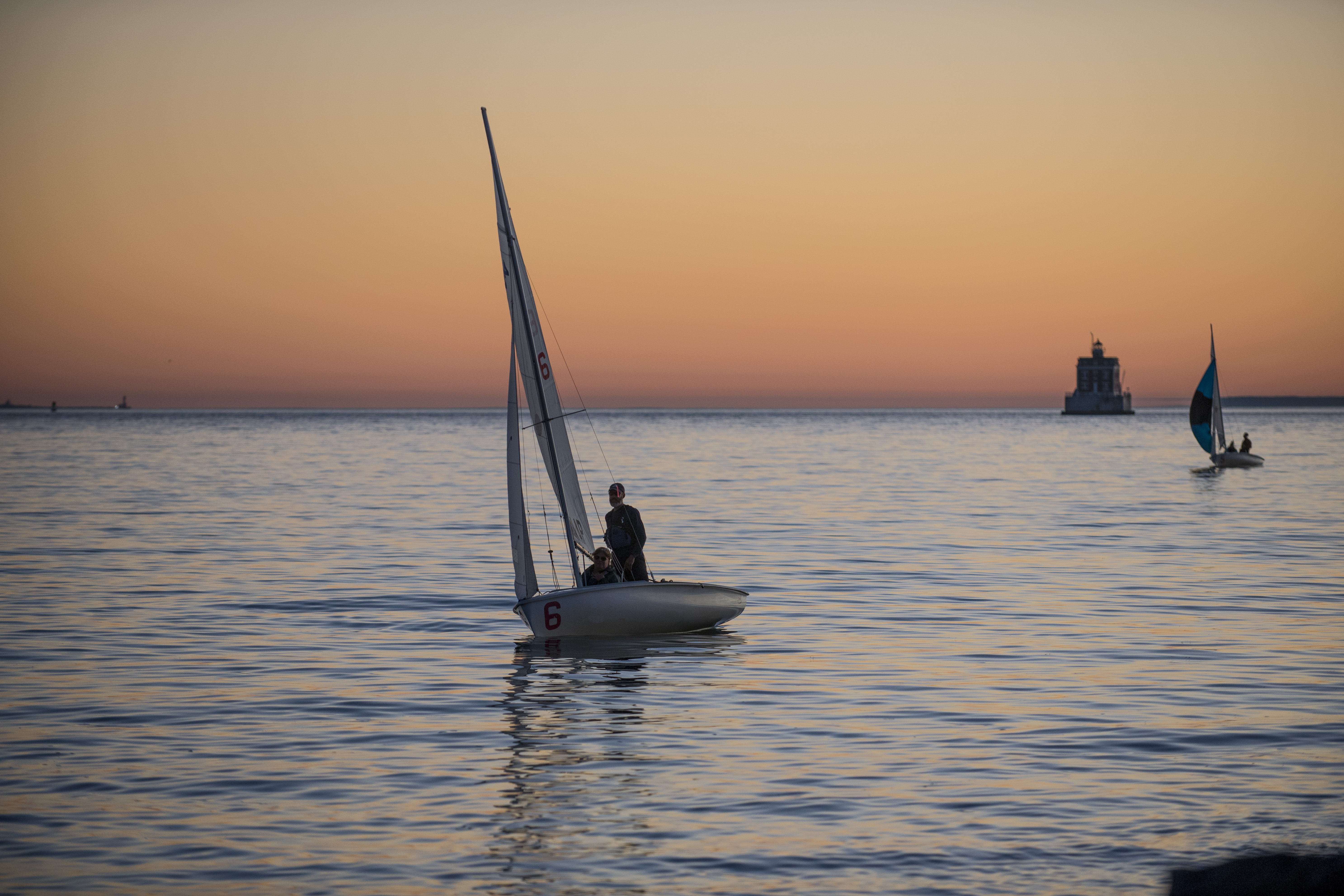 A sailboat in Long Island Sound at sunset