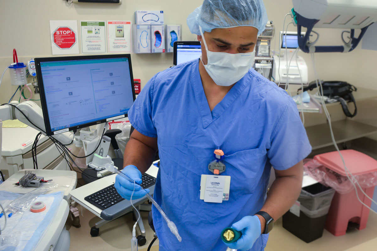 Alejandro Bautista preparing anesthesia in operating room