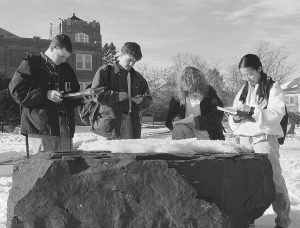 Students taking Geology 102 examine a rock at the old Geology Park, which was near Hawley Armory, in 1996. (Jonathan Cohen/UConn File Photo)