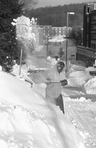 Hector Hernandez of UConn Facilities shovels snow along Hillside Road after a storm in 1996. (UConn File Photo)