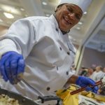 Chef Lucinda Simms adding ingredients to a pan at the Culinary Olympics on Jan. 14, 2020. (Sean Flynn/UConn Photo)