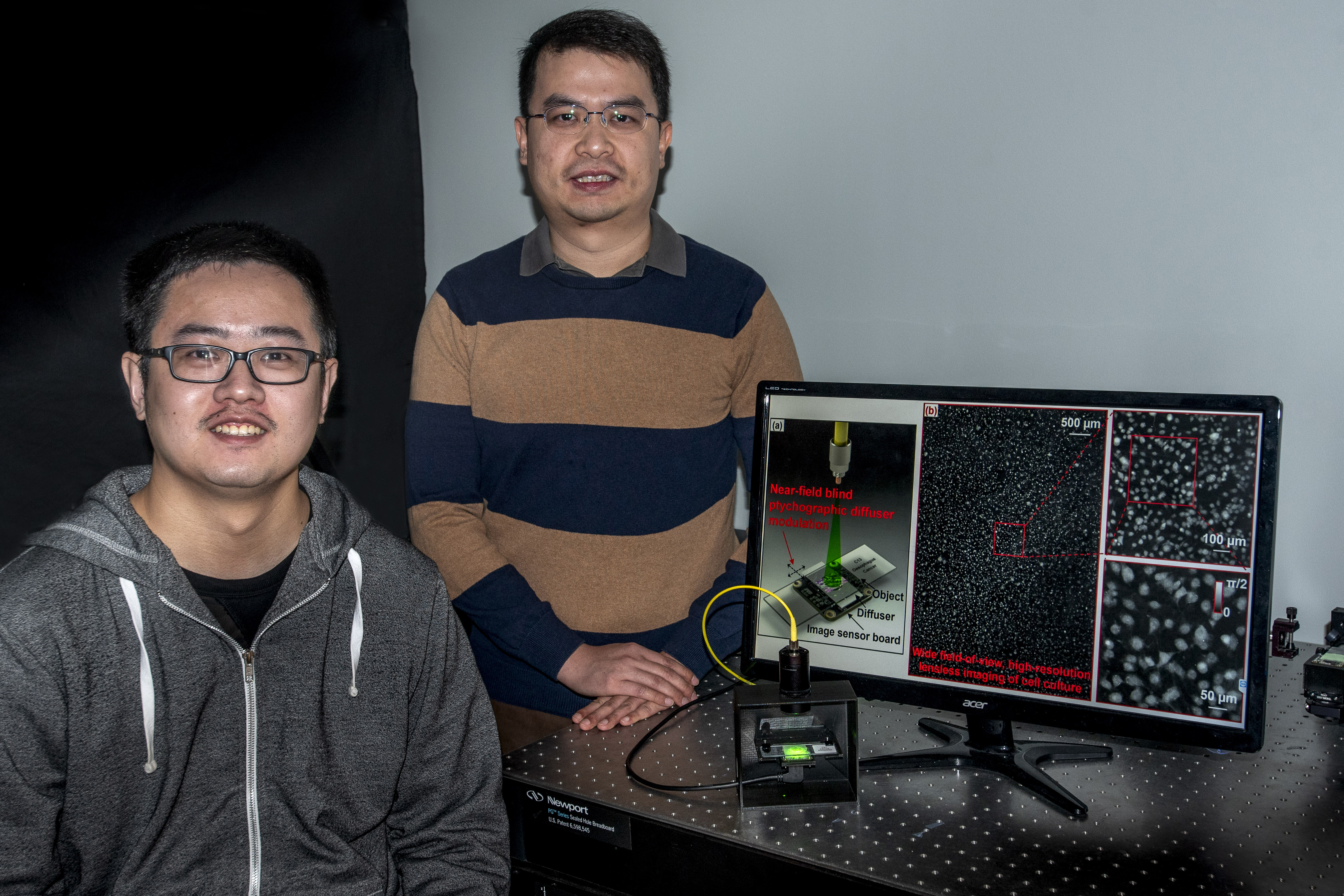 Graduate student Shaowei Jiang (seated) with Professor Guoan Zheng at his lab in the Engineering Science Building on Feb. 13, 2020. (UConn Photo/Sean Flynn)