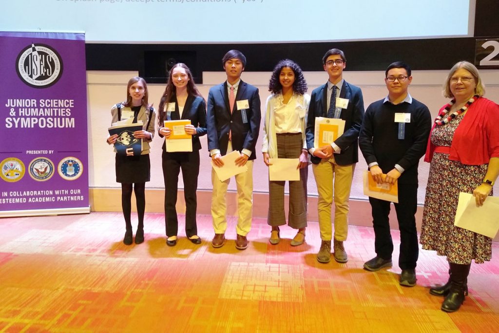 Students holding their award certificates