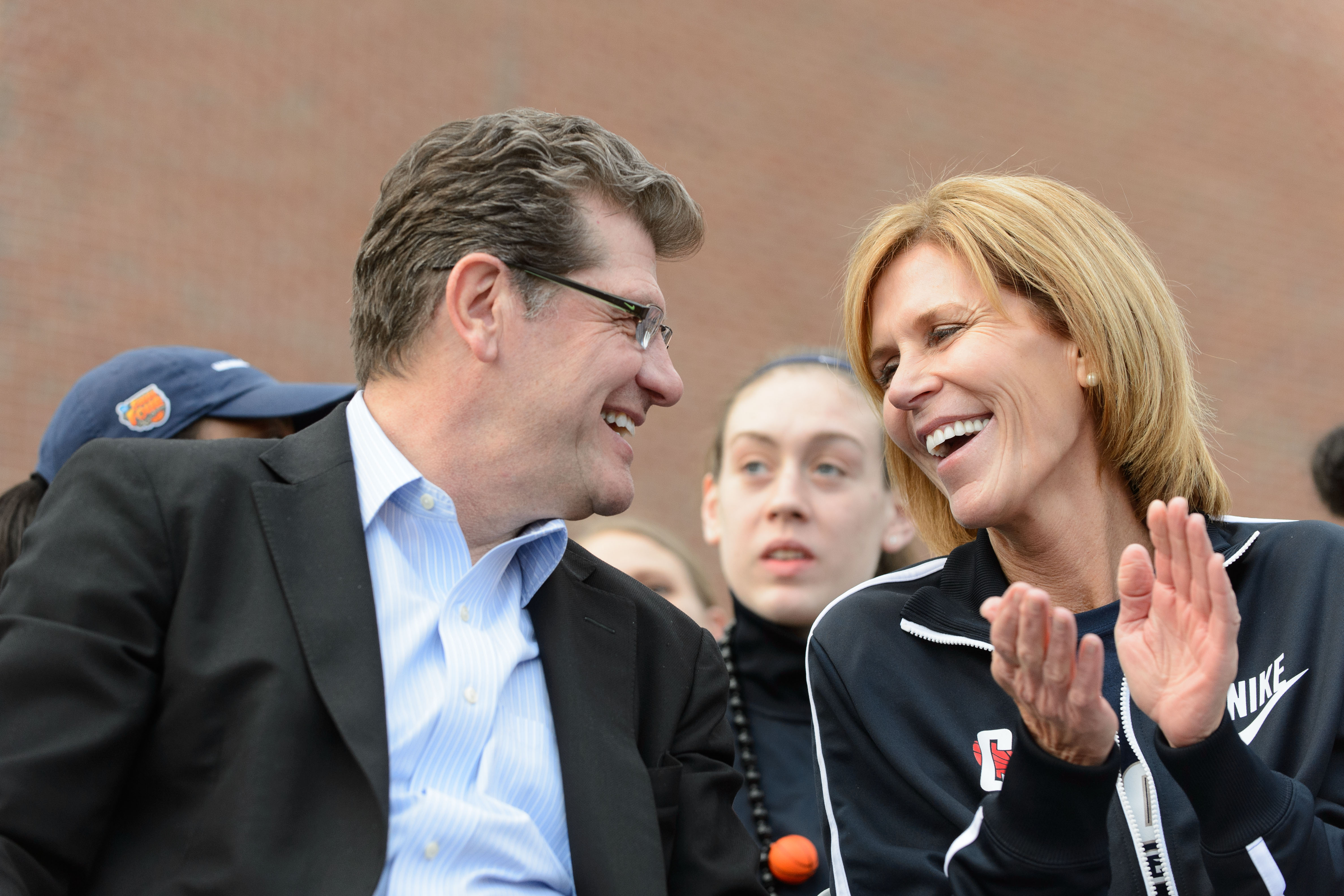 Coach Geno Auriemma and associate head coach Chris Dailey share a laugh during a rally held along Fairfield Way on April 10, 2013 to celebrate the Women's Basketball win over Louisville. (Peter Morenus/UConn Photo)