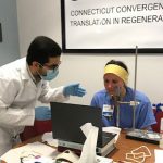 Amir Seyedsalehi (left), a graduate research assistant in the Connecticut Convergence Institute for Translation in Regenerative Engineering, works with UConn Health float pool nurse Amy Lipka to create a customized mask frame using facial recognition software. (Photo by Eva Homan)