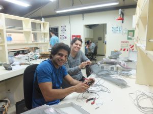 Christopher Martinez and Breanna Mora building the portable heaters. Martinez is preparing the connecting wires on the heaters and Mora is wiring parts of a controller together