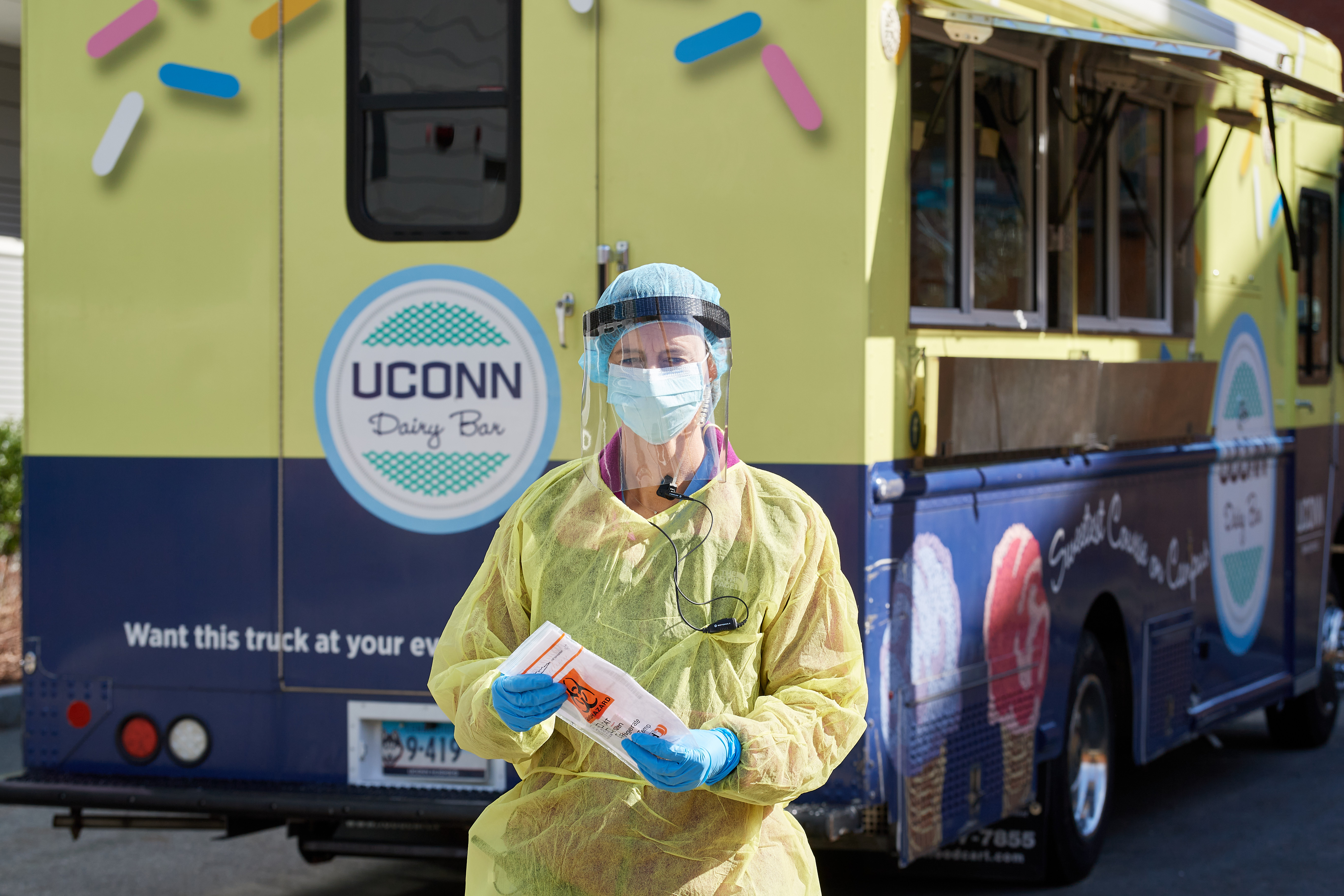 Beth Schweitzer '98 MD, takes a sample kit from the Dairy Bar truck pressed into service for drive up COVID-19 corona virus testing outside Student Health Services on April 14, 2020.