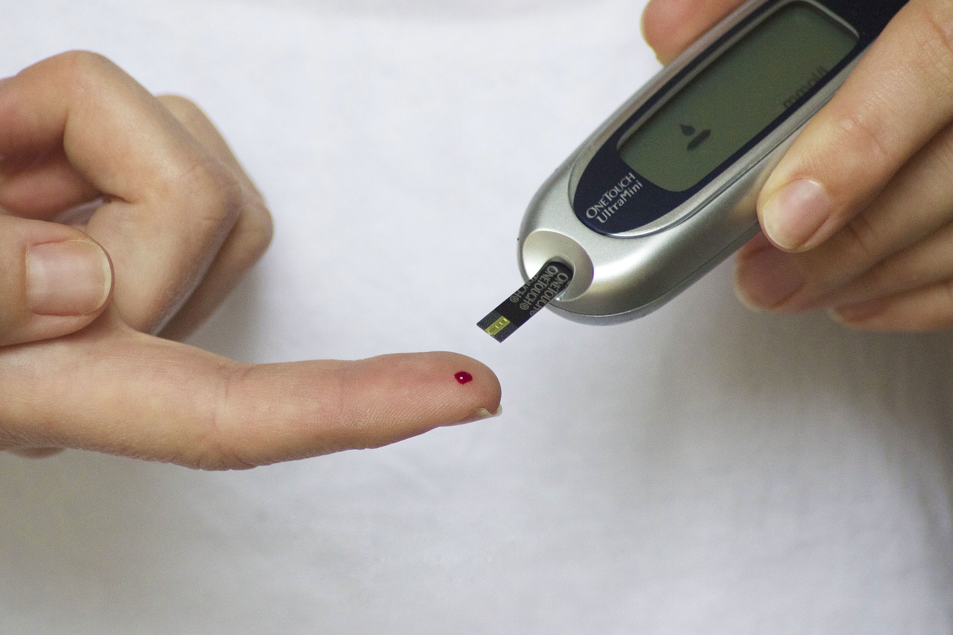 Female hands doing diabetes prick test
