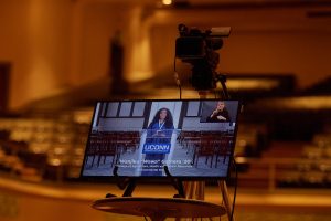A television monitor shows Wanjiku Gatheru '20 (CAHNR) addressing the degree candidates during the virtual Commencement ceremony broadcast from the Jorgensen Center for the Performing Arts on May 9, 2020. (Peter Morenus/UConn Photo)