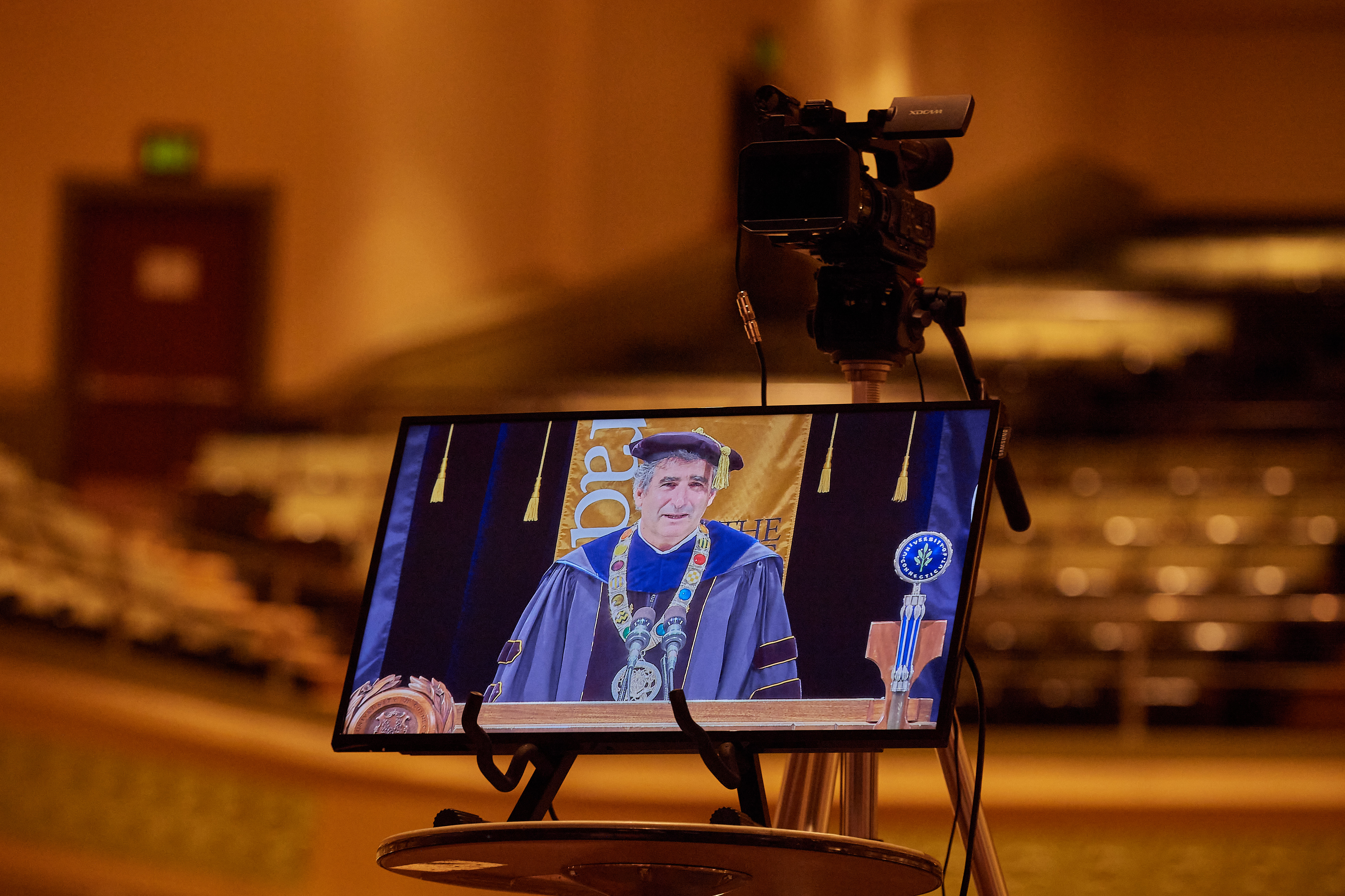 A television monitor shows President Thomas Katsouleas during the virtual Commencement ceremony broadcast from the Jorgensen Center for the Performing Arts on May 9, 2020.
