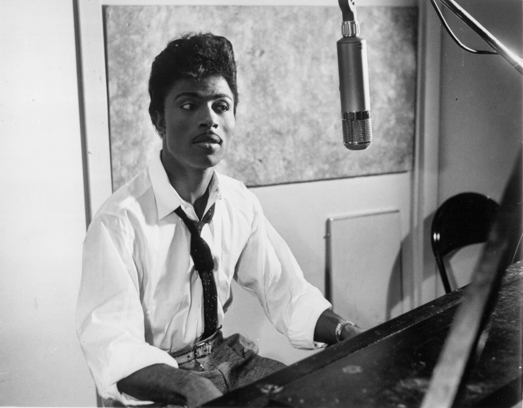 Musician Little Richard performs on the recording studio at a microphone and piano in circa 1959.