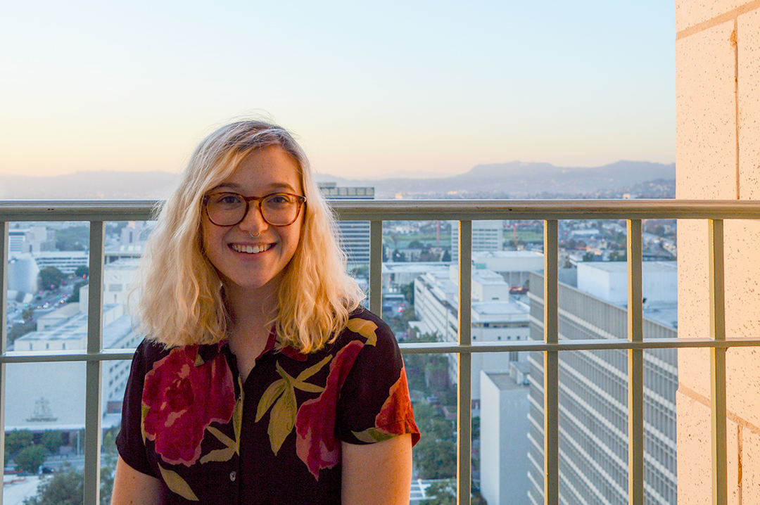 Morgan Allegrove-Hodges '20 (CLAS) smiles for a photo on a balcony at sunset.