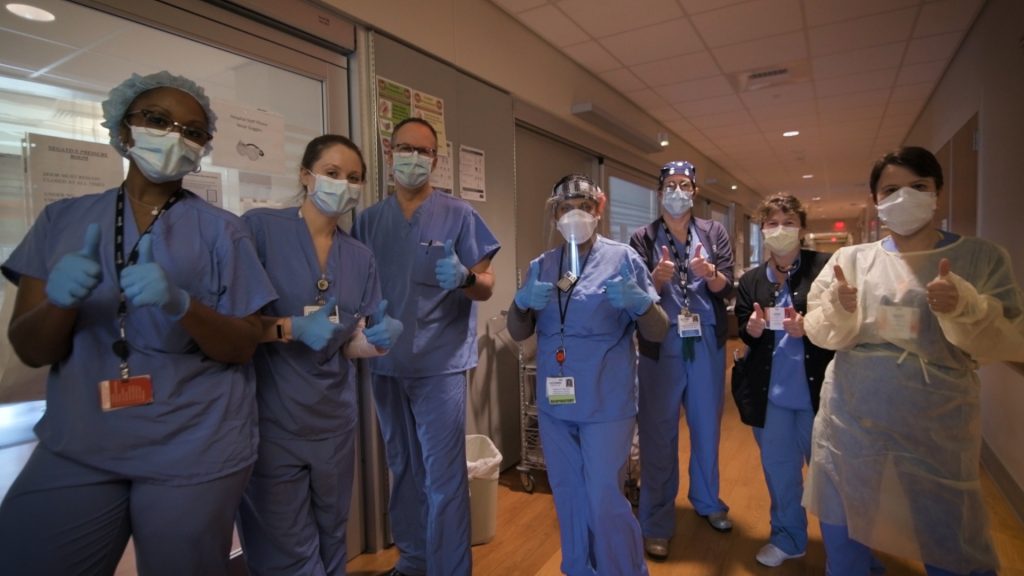 A group of UConn Health nurses wearing hospital scrubs and face masks.