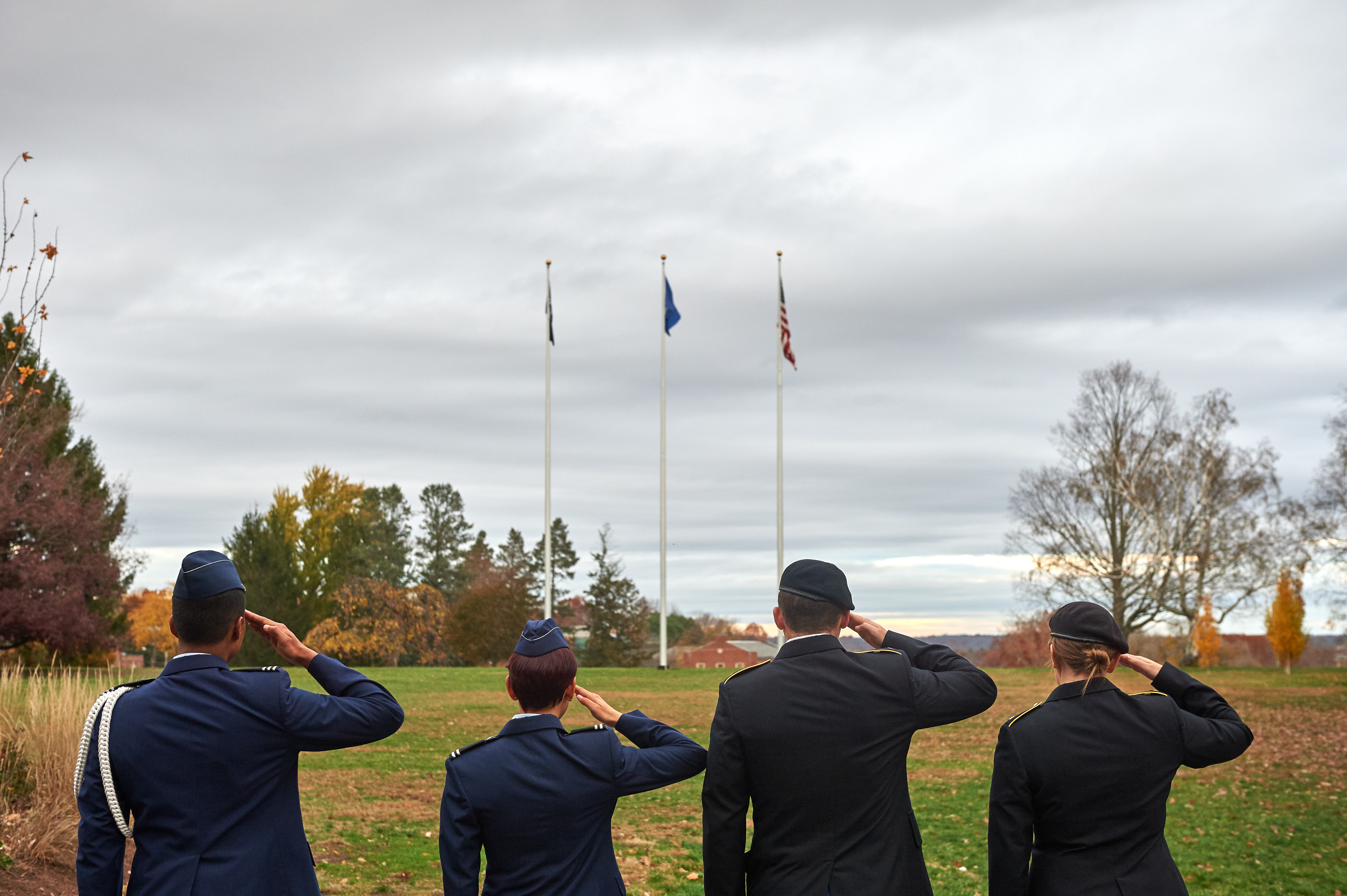 Army and Air Force ROTC members salute the flag on the Great Lawn
