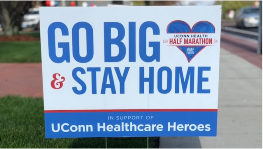 A lawn sign advertising the UConn Health Half-Marathon.