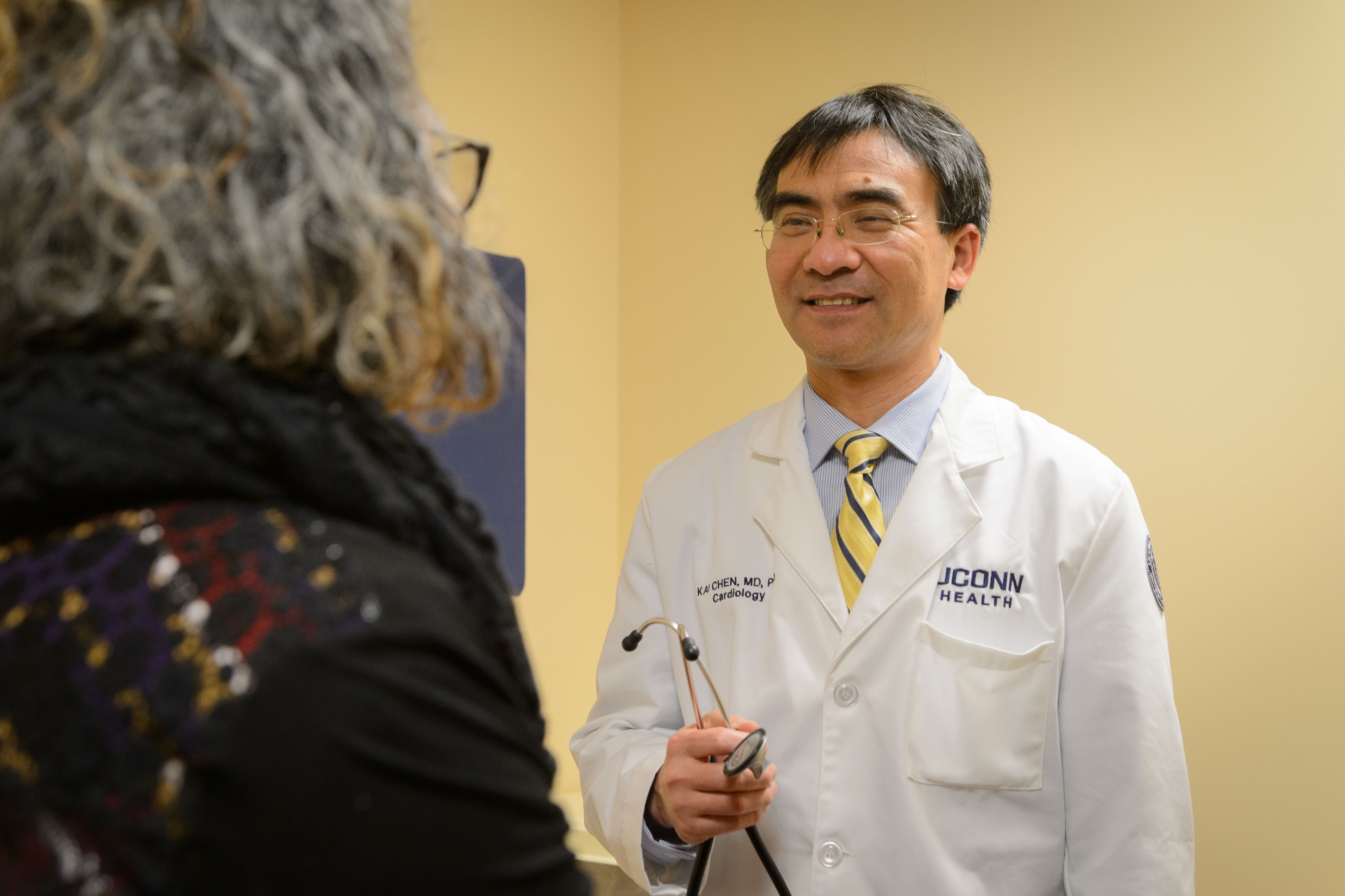 Dr. Kai Chen of UConn Health meets with a patient.