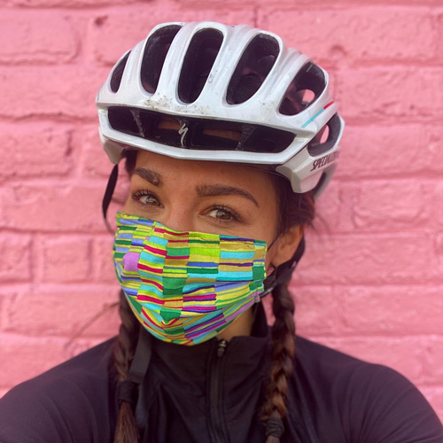 Woman in bike helmet wearing a mask.