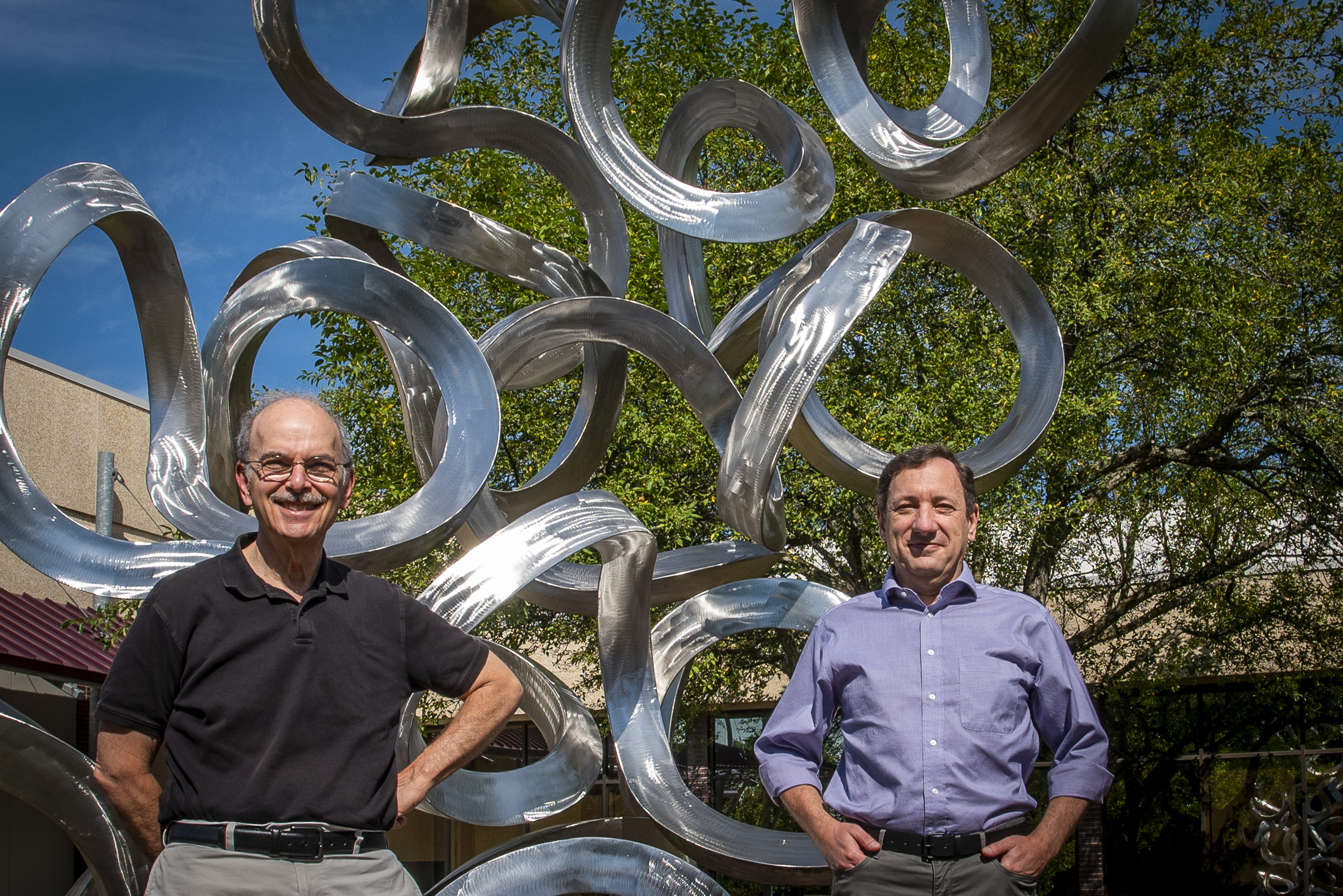 Researchers Les Loew, left, and Pedro Mendes outside the Cell and Genome building at UConn Health in Farmington on July 13, 2020.