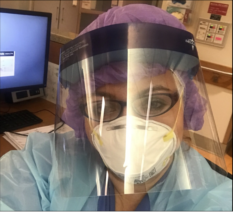UConn Health nurse Maria Budzinski posing in a face shield and N95 mask.
