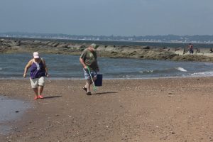 Volunteers collect trash at Lighthouse Point Park in New Haven as part of the “Break the Single-Use Plastic Habit” campaign by Connecticut Sea Grant and other groups last summer.