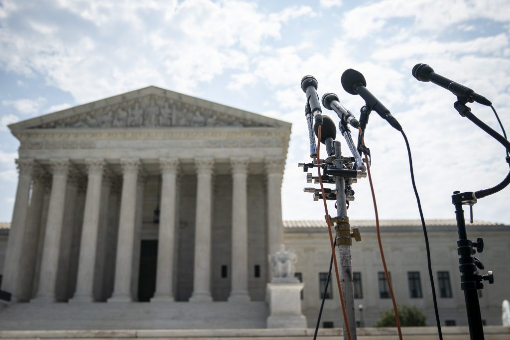 The US Supreme Court building, with microphone stands.