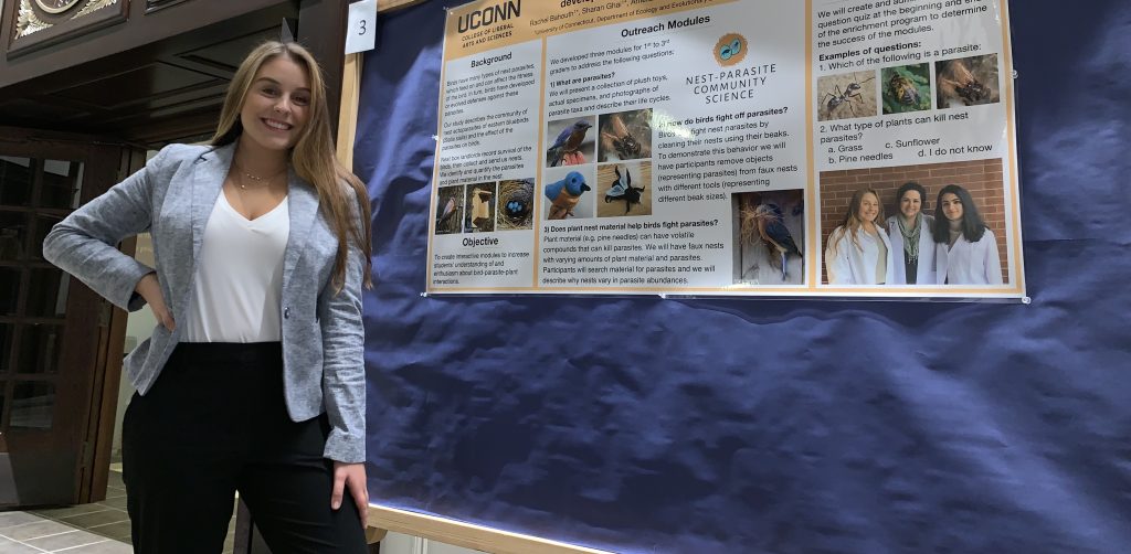 a woman in front of a sign