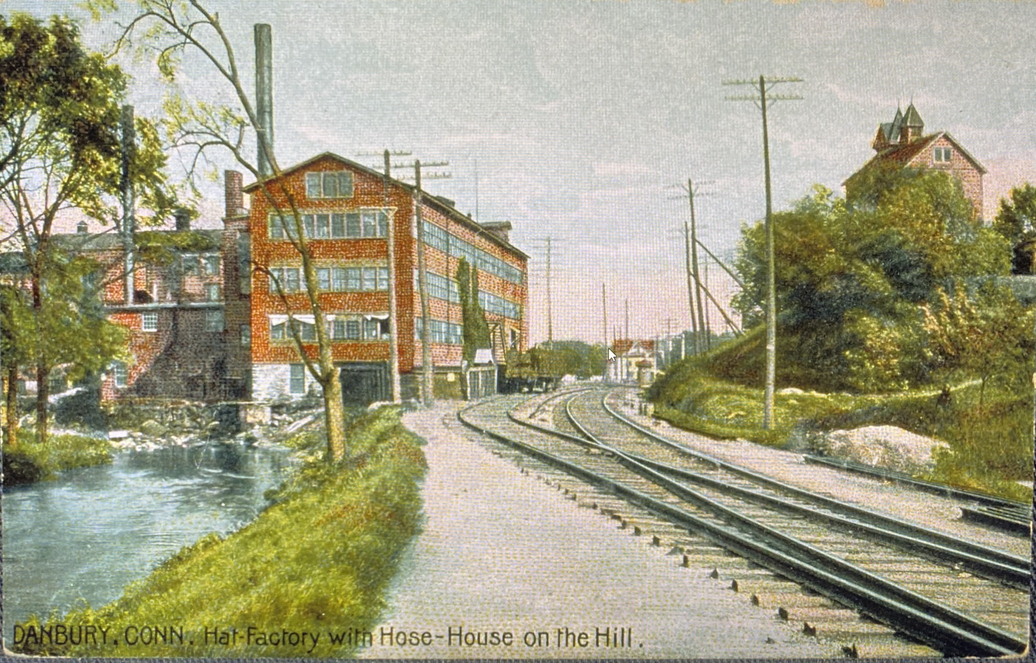 A colored postcard image of hat factory in Danbury