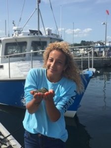 Larissa Tabb holds an oyster at UConn Avery Point.