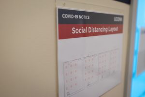 Signs with social distancing guidelines will be familiar sights on all campuses (Sean Flynn/UConn Photo)