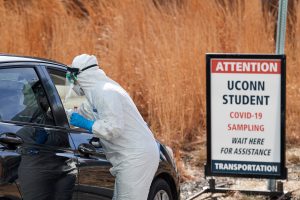 Valerie Kiefer '99 MS, '19 DNP, nurse practitioner, takes a sample from a patient during drive up COVID-19 corona virus testing outside Student Health Services on April 14, 2020. (Peter Morenus/UConn Photo)