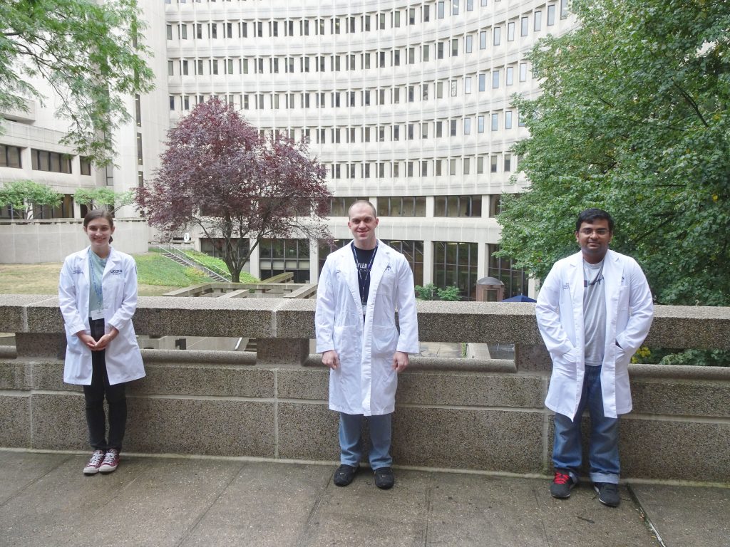 From left, research assistant Paige Woods, Biomedical Science PhD student Adam Tanguay, and Biomedical Engineering student Nikhil Menon, who assist Schmidt with his research.