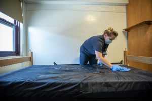 Custodian Shannon Miller sanitizes student’s rooms in McMahon Residence Hall during the Covid 19 pandemic on July 2, 2020. (UConn photo/SeanFlynn)