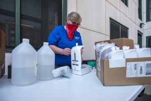 Maintenance Supervisor Linda Sumner of Facility Operations preparing soap dispensers for the Chemistry Building on July 2. (UConn photo/SeanFlynn)