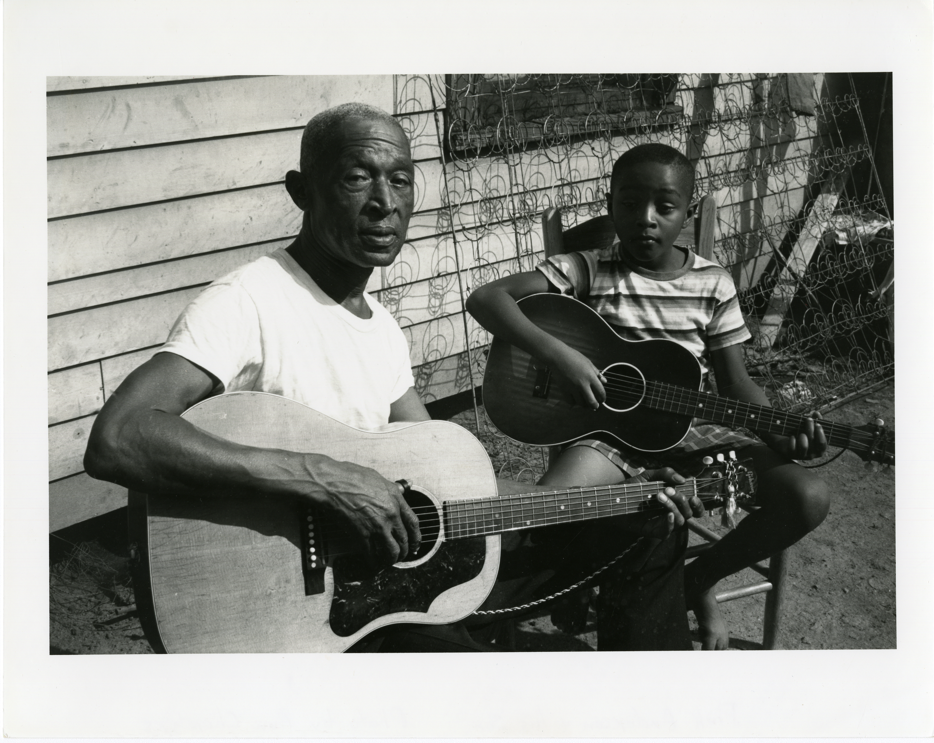 Pinkney “Pink” Anderson with his son Alvin, known as “Little Pink,” at their South Carolina home in 1962 when they appeared in the film “The Blues,” made by Samuel and Ann Charters.