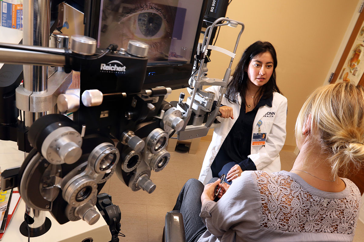 Dr. Falcone with equipment in eye exam room