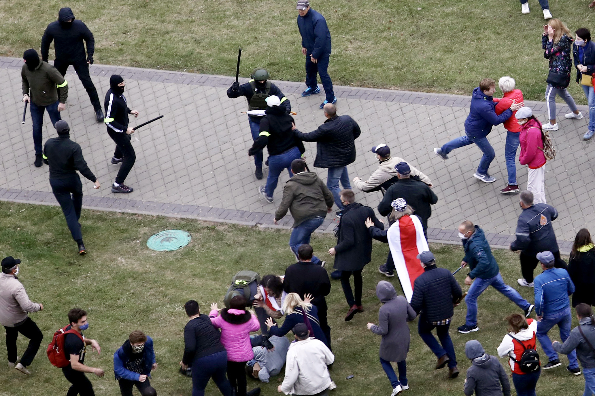 Police with batons attack pro-democracy demonstrators in Belarus.