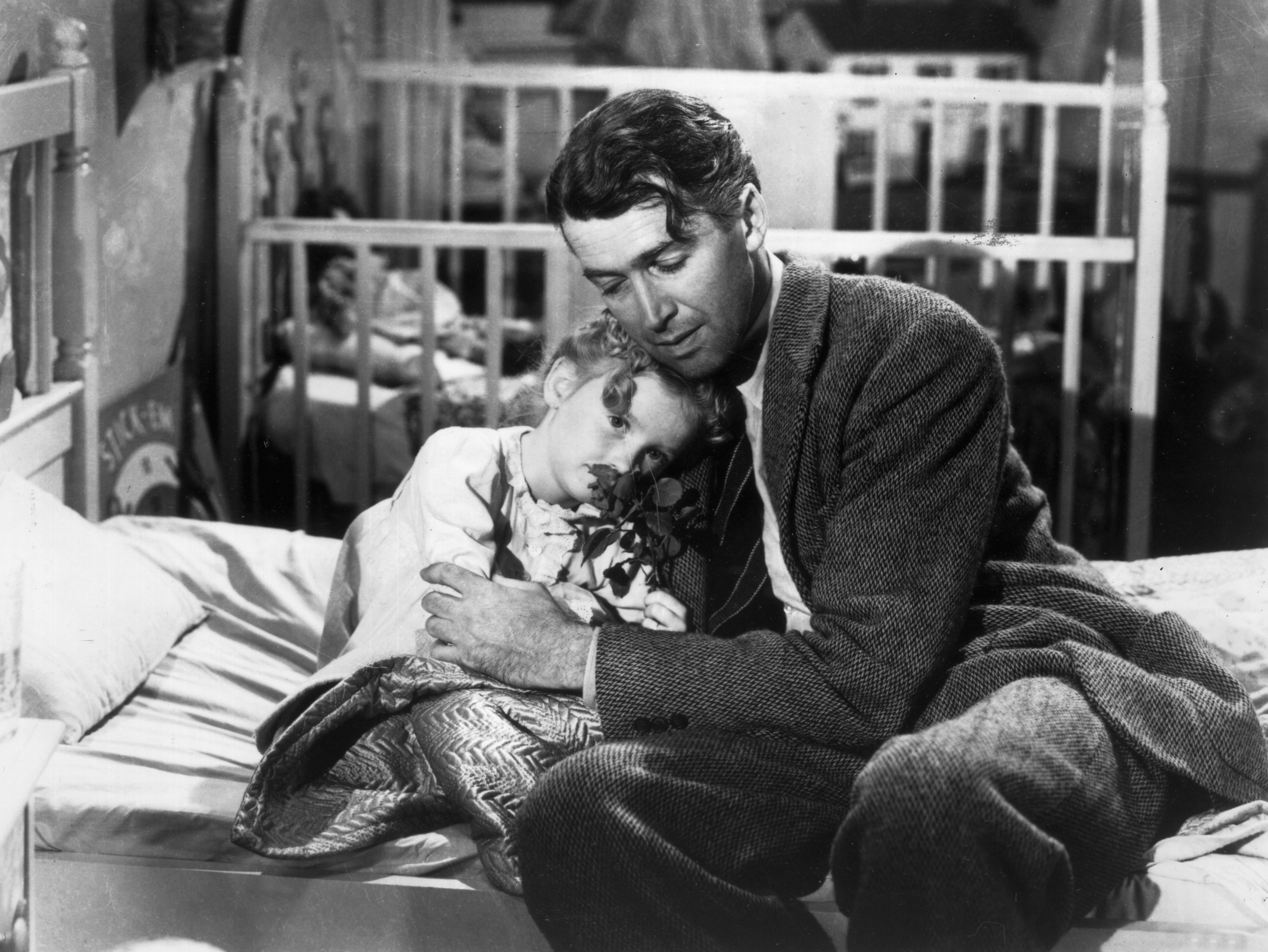 1946: American actor James Stewart (1908 - 1997) as George Bailey, hugs actor Karolyn Grimes, who plays Zuzu his daughter, in a still from director Frank Capra's Christmas classic film, 'It's a Wonderful Life'. (Photo by Hulton Archive/Getty Images)