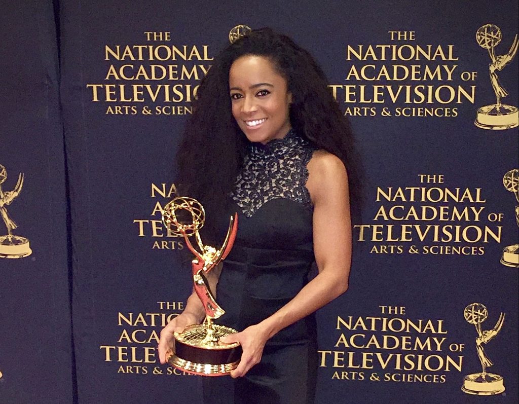 Lauren Stowell '06 holds one of her five Emmy awards on the red carpet at the awards ceremony.