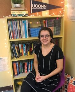 Jessica Stargardter sits in front of book shelf.
