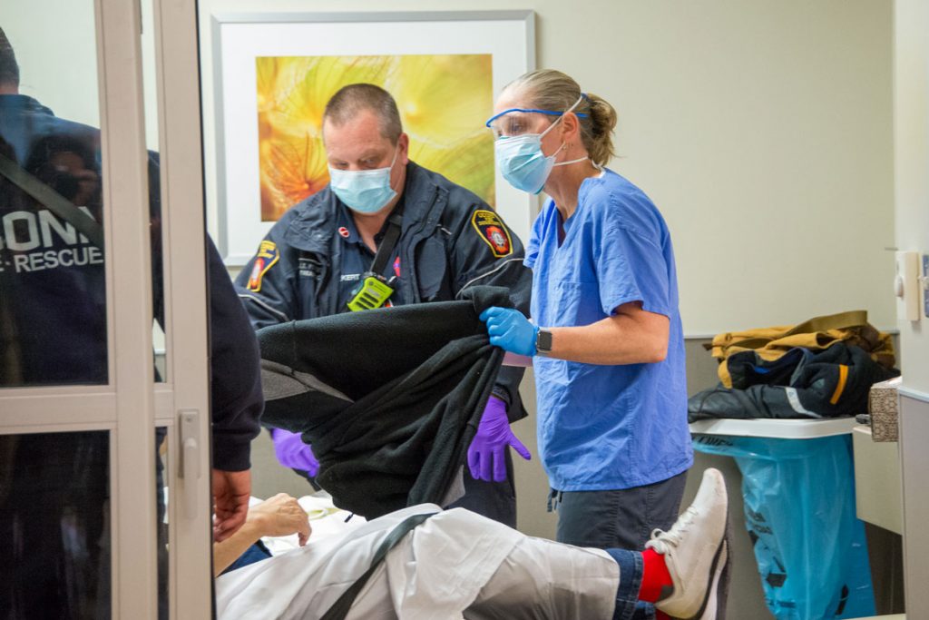 EMT and provider with a patient in the ED