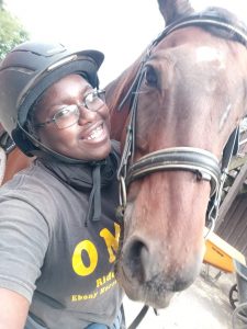 UConn senior LaShawnda Phillips posing with her horse. 