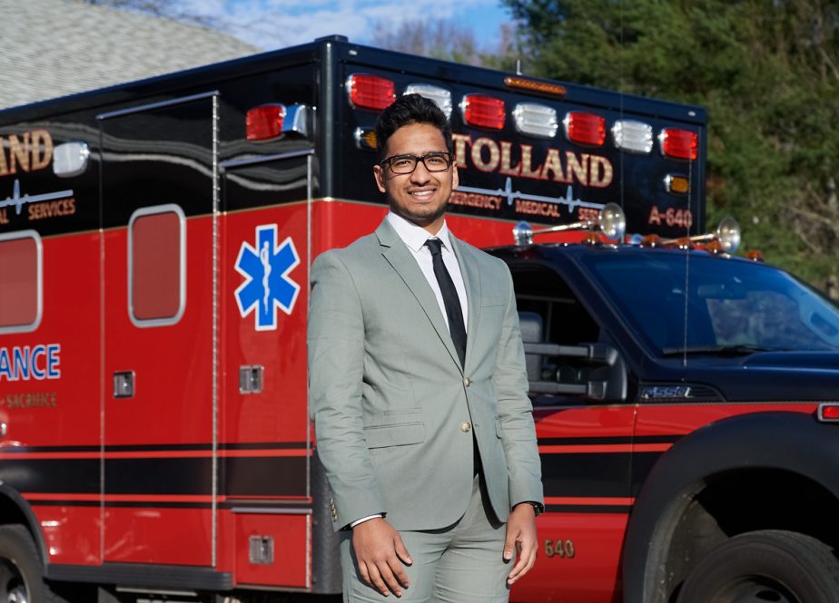Vishal Patel standing in front of an ambulence